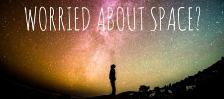 Silhouette of a person gazing at a colorful starry sky with the text 'Worried About Space?' promoting space exploration interest