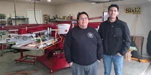 Jon and Joe screen printing in their Dallas garage for Six12 Printing.